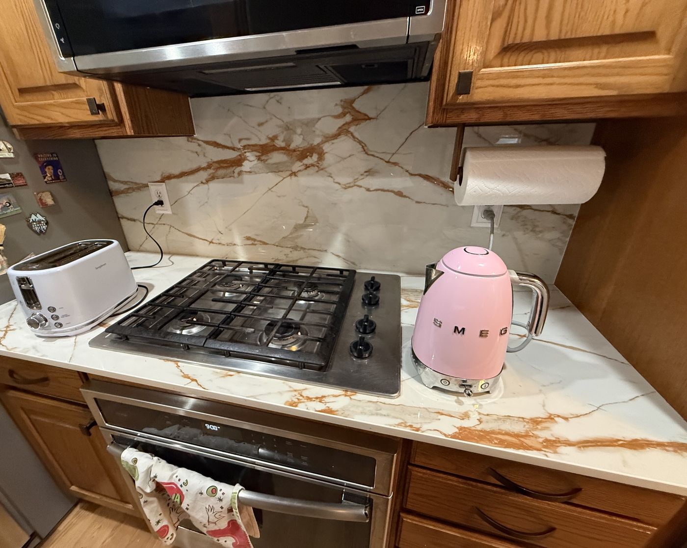 Kitchen counter with a toaster and electric kettle plugged into outlets on the backsplash